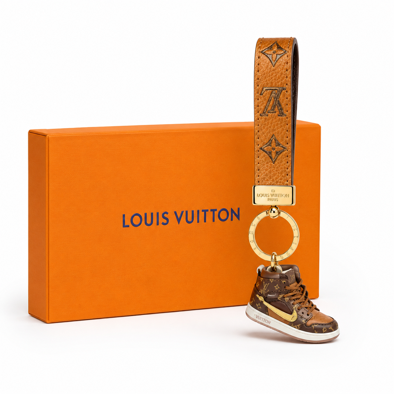 Louis Vuitton keychain features a black leather strap
