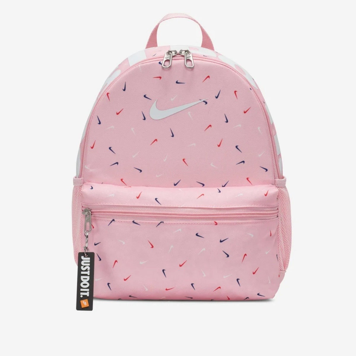 Pink Nike mini backpack with multicolor swoosh print on a light pink background.